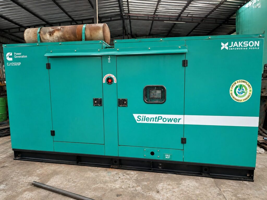Used Cummins diesel generator with Jakson silent enclosure installed in industrial workshop